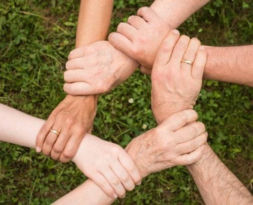 team holding hands with each other