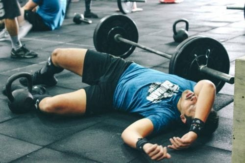 man laying exhausted on the floor