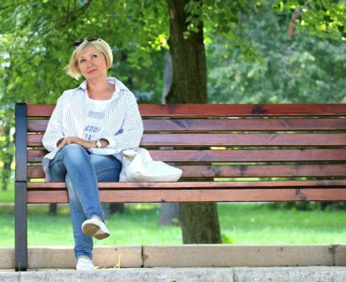 woman on bench with trees