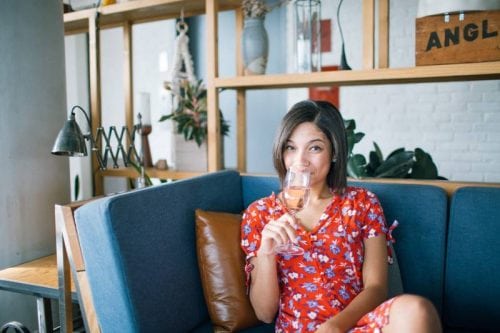 girl drinking wine on couch