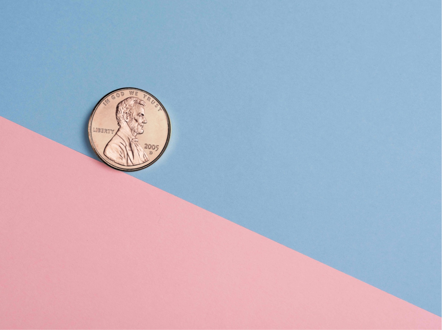 a penny on a pink and blue surface