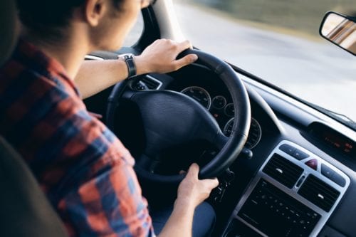 Interior picture of a father driving a car