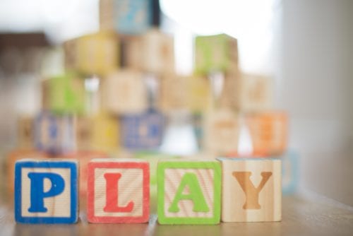 Wooden blocks spell out the world PLAY