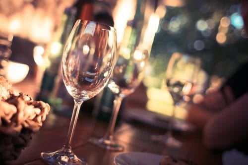 Close up of two wine glasses at a party