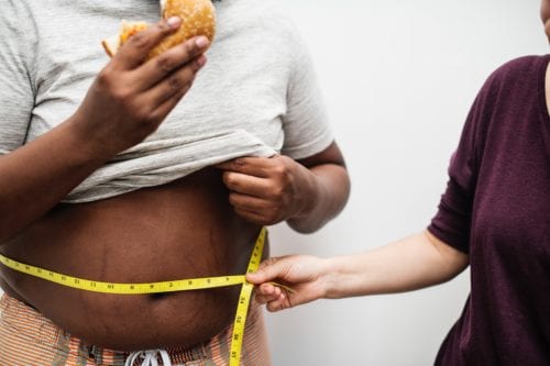 A measuring tape around a large stomach