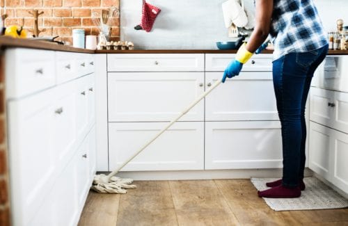 A person cleans the kitchen for extra money