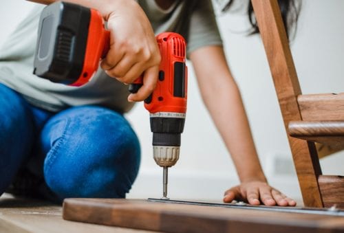 A person drilling a hole