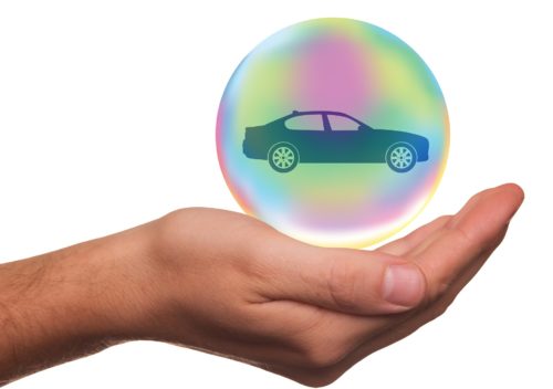 A person holding a car in a bubble