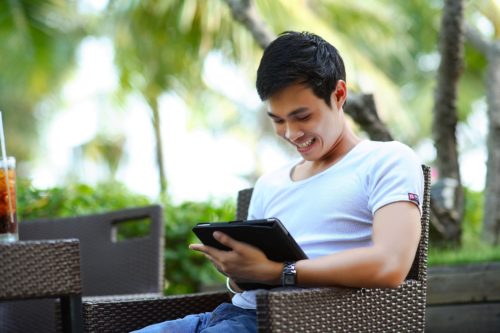 Man on tablet smiling