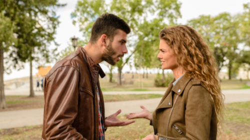 a man and woman arguing at the park