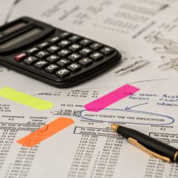 A calculator and a page of financial calculations