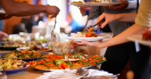 people serving themselves at a buffet