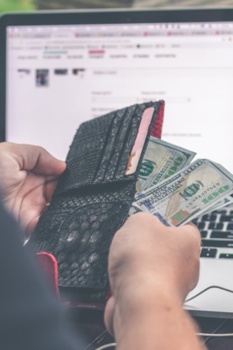 an open wallet in front of a computer screen