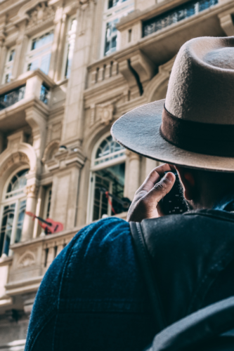 A person looking up at a historical building