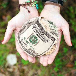 Hands holding a wad of cash