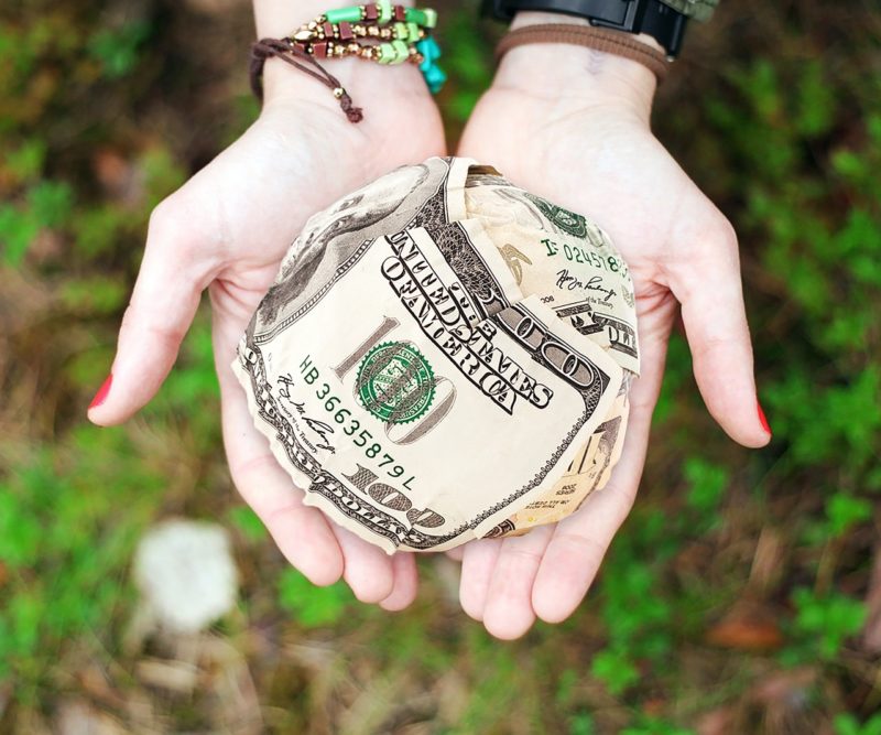 Hands holding a wad of cash