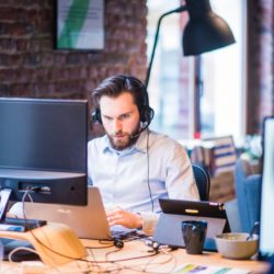 man at office desk on the phone