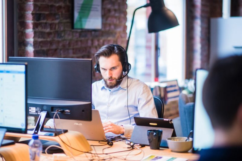 man at office desk on the phone